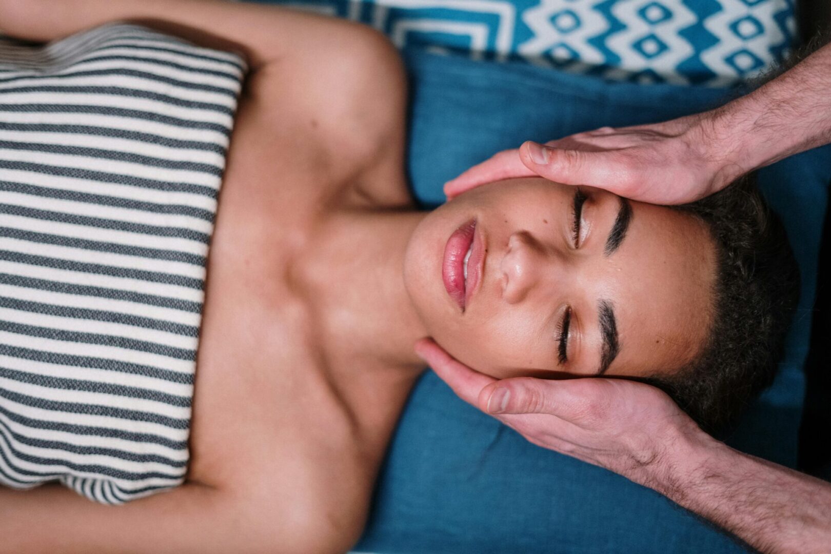 A woman laying down with her eyes closed.